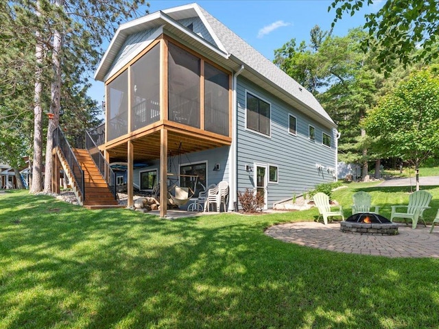 12144 Sylvan Dr SW, Sylvan Twp, MN 56473 - back of house featuring a fire pit, a patio, a lawn, and a sunroom