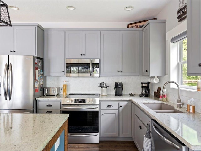 12144 Sylvan Dr SW, Sylvan Twp, MN 56473 - kitchen featuring stainless steel appliances, gray cabinetry, light stone counters, tasteful backsplash, and recessed lighting