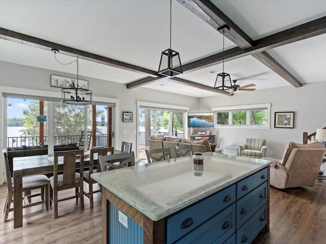 12144 Sylvan Dr SW, Sylvan Twp, MN 56473 - kitchen with blue cabinets, open floor plan, beamed ceiling, wood finished floors, and a ceiling fan