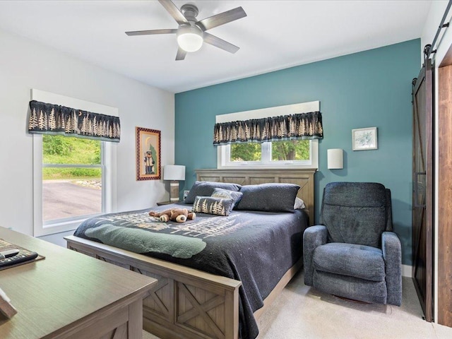 12144 Sylvan Dr SW, Sylvan Twp, MN 56473 - bedroom with a barn door, carpet, and ceiling fan
