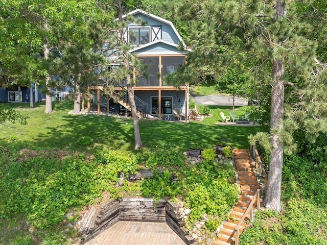 12144 Sylvan Dr SW, Sylvan Twp, MN 56473 - view of green lawn featuring stairway, a deck, and a sunroom