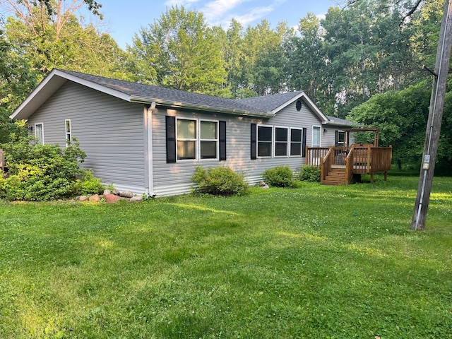 23324 State Highway 107, Grasston, MN 55030 - view of property exterior with a wooden deck, a lawn, and a shingled roof