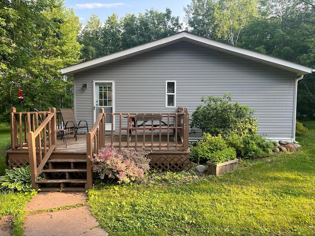 23324 State Highway 107, Grasston, MN 55030 - rear view of property with a lawn and a deck