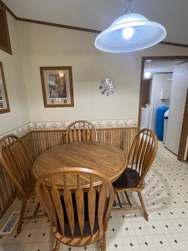 23324 State Highway 107, Grasston, MN 55030 - dining area with crown molding, wainscoting, light flooring, and washer / dryer