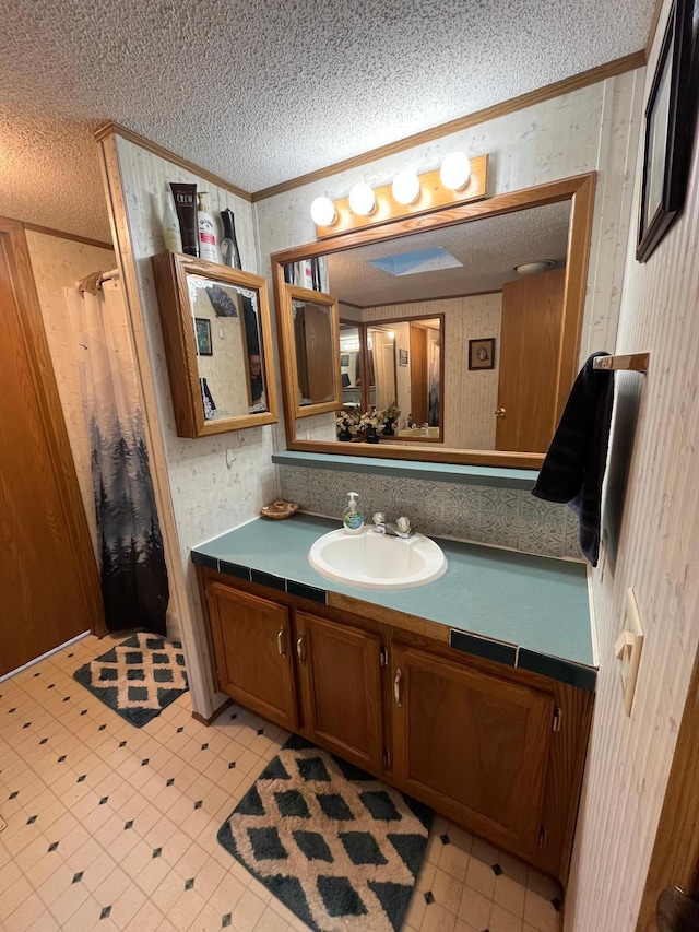 23324 State Highway 107, Grasston, MN 55030 - bathroom with a textured ceiling, ornamental molding, vanity, and wallpapered walls