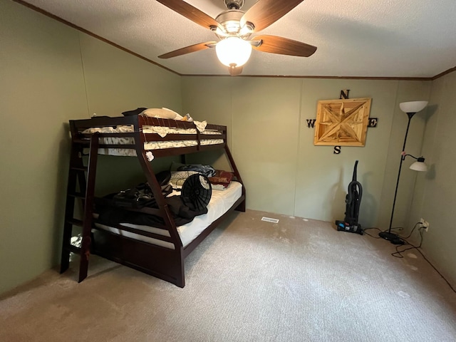 23324 State Highway 107, Grasston, MN 55030 - bedroom with carpet floors, ornamental molding, a textured ceiling, and ceiling fan