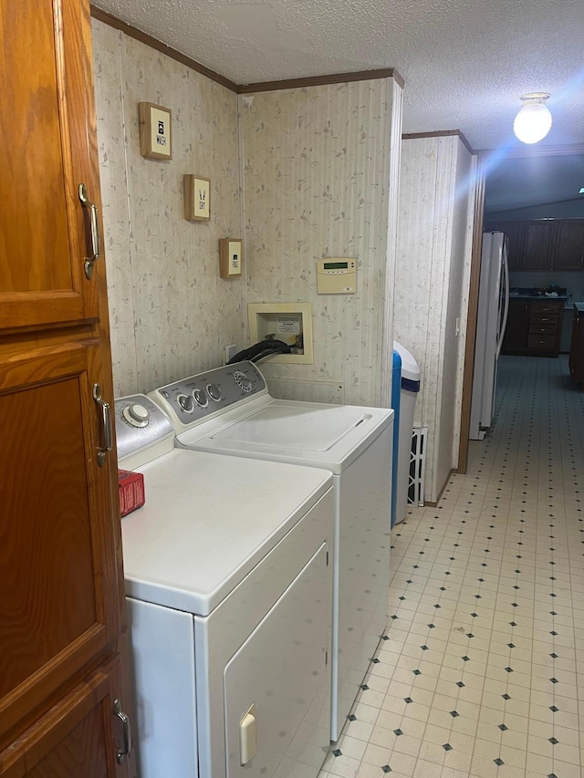 23324 State Highway 107, Grasston, MN 55030 - laundry room with a textured ceiling, crown molding, washer and dryer, and light floors