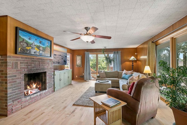 895 Front, Saint Paul, MN 55103 - living area with wood walls, ceiling fan, light wood-style floors, and a fireplace