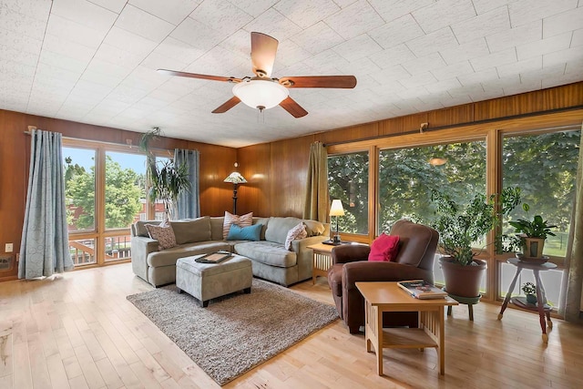 895 Front, Saint Paul, MN 55103 - living room featuring ceiling fan, wooden walls, and light wood-style floors