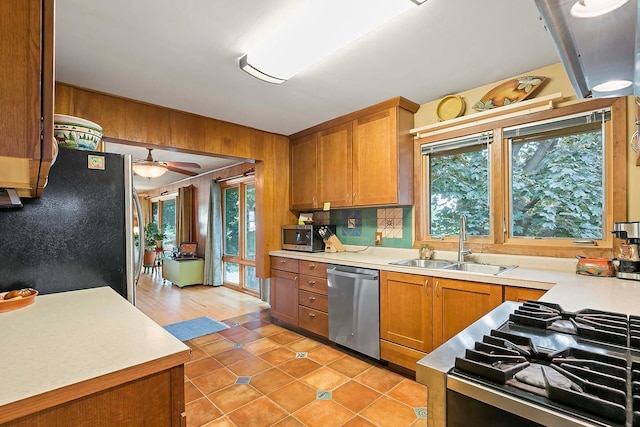 895 Front, Saint Paul, MN 55103 - kitchen with stainless steel appliances, plenty of natural light, brown cabinetry, and wooden walls