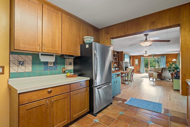 895 Front, Saint Paul, MN 55103 - kitchen featuring freestanding refrigerator, ceiling fan, tasteful backsplash, and brown cabinets