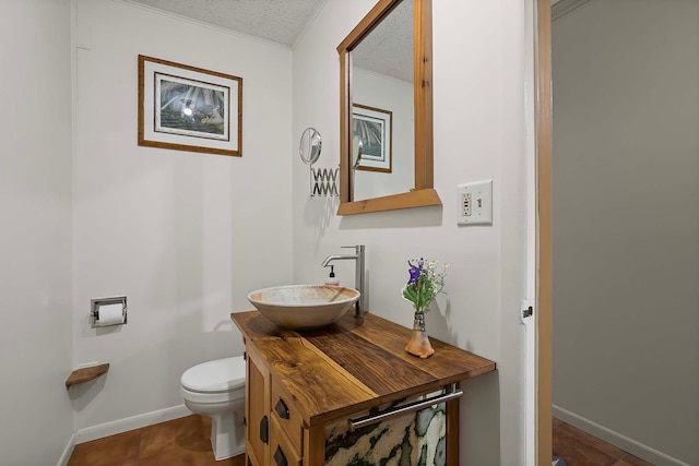 895 Front, Saint Paul, MN 55103 - bathroom featuring a textured ceiling, vanity, ornamental molding, and tile patterned floors