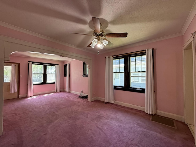 845 Sims Ave, Saint Paul, MN 55106 - spare room featuring arched walkways, ornamental molding, ceiling fan, carpet, and a textured ceiling