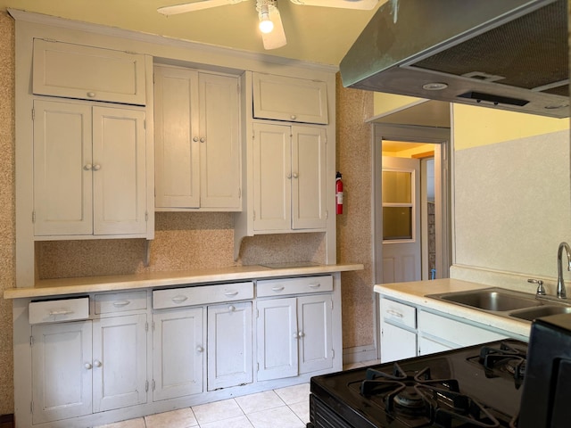 845 Sims Ave, Saint Paul, MN 55106 - kitchen featuring a sink, range hood, black gas range oven, light countertops, and light tile patterned floors