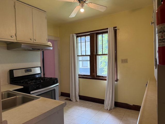 845 Sims Ave, Saint Paul, MN 55106 - kitchen with range hood, gas stove, a sink, baseboards, and light countertops