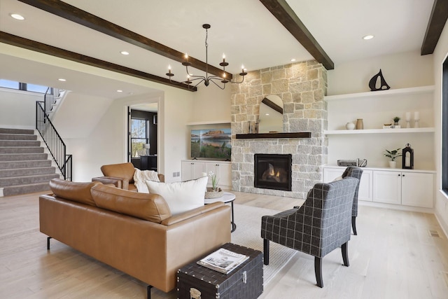 21281 Dorothy Way, Spring Lake Twp, MN 55372 - living room featuring beam ceiling, light wood-style floors, stairway, a stone fireplace, and recessed lighting