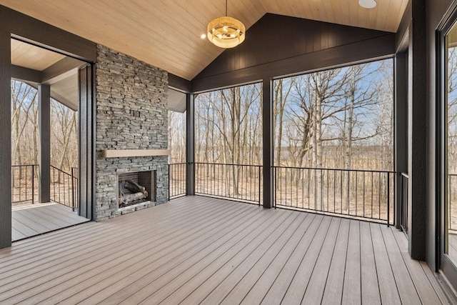 21281 Dorothy Way, Spring Lake Twp, MN 55372 - unfurnished sunroom featuring an outdoor stone fireplace and vaulted ceiling