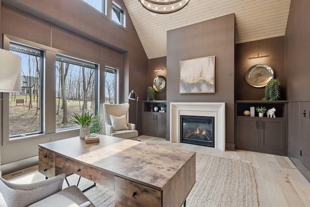 21281 Dorothy Way, Spring Lake Twp, MN 55372 - living area with healthy amount of natural light, wood ceiling, light wood finished floors, a glass covered fireplace, and high vaulted ceiling