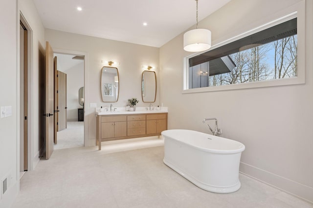 21281 Dorothy Way, Spring Lake Twp, MN 55372 - full bathroom with double vanity, a freestanding bath, baseboards, and recessed lighting