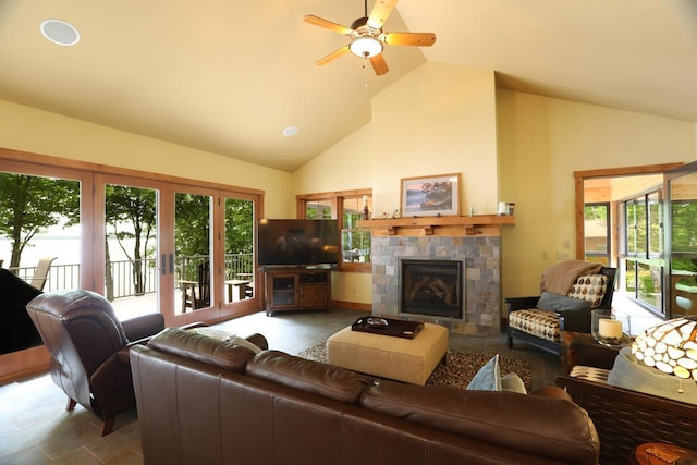 2438 Birch Point Rd, Greenwood Twp, MN 55790 - living area featuring a tile fireplace, ceiling fan, and high vaulted ceiling