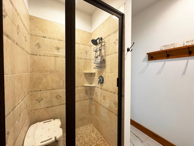 2438 Birch Point Rd, Greenwood Twp, MN 55790 - bathroom with a shower stall, marble finish floors, baseboards, and a walk in closet