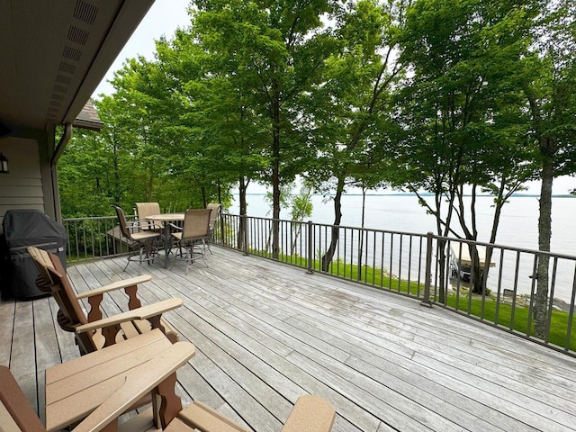2438 Birch Point Rd, Greenwood Twp, MN 55790 - wooden deck with outdoor dining space, a water view, and a grill