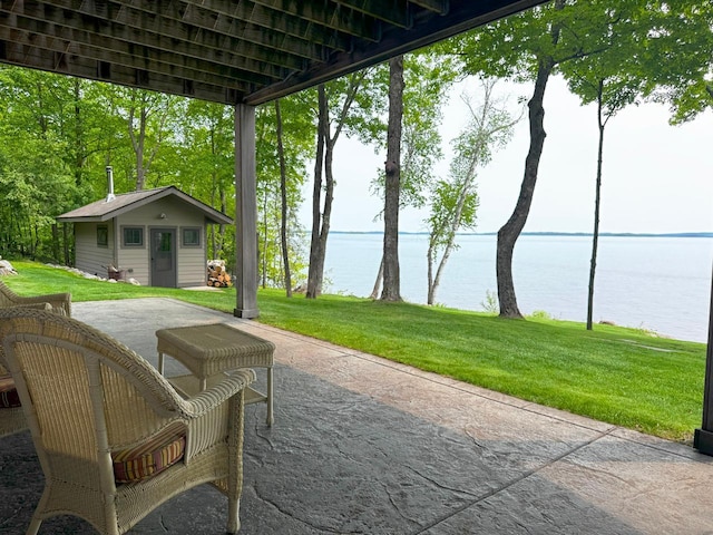 2438 Birch Point Rd, Greenwood Twp, MN 55790 - view of patio with a water view and an outbuilding