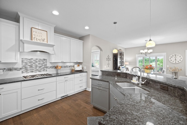 3710 Talero Curv, Chaska, MN 55318 - kitchen with a sink, stainless steel gas cooktop, arched walkways, decorative backsplash, and a chandelier
