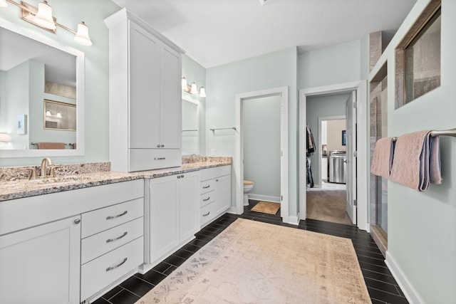 3710 Talero Curv, Chaska, MN 55318 - bathroom featuring double vanity, toilet, wood finish floors, and baseboards