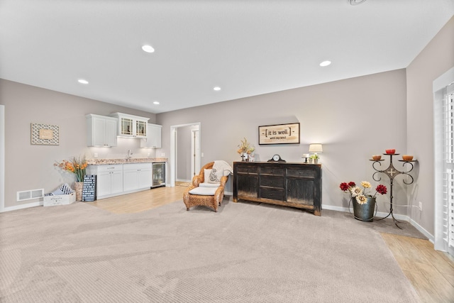 3710 Talero Curv, Chaska, MN 55318 - sitting room featuring beverage cooler, baseboards, recessed lighting, bar, and light wood-style floors