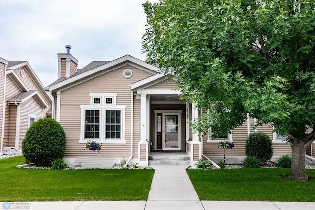 1365 Highpointe Dr N, Fargo, ND 58102 - view of front of house with a front yard and a chimney
