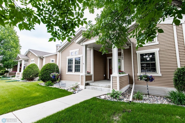 1365 Highpointe Dr N, Fargo, ND 58102 - view of front of house with covered porch and a front lawn