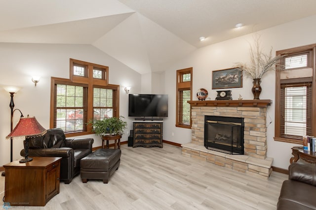 1365 Highpointe Dr N, Fargo, ND 58102 - living room with light wood-type flooring, a stone fireplace, lofted ceiling, and plenty of natural light