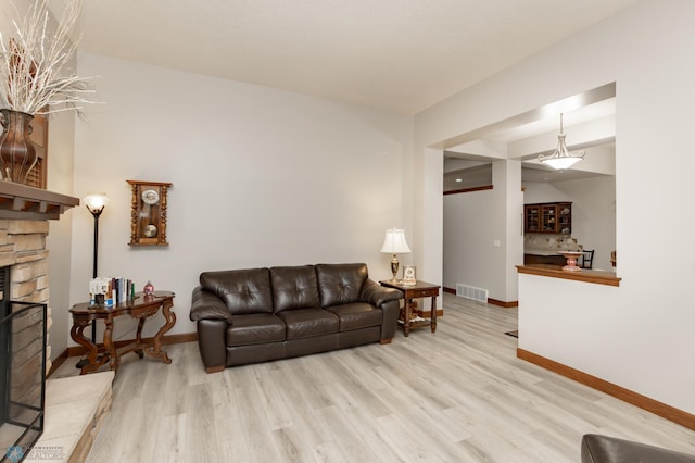 1365 Highpointe Dr N, Fargo, ND 58102 - living room featuring wood finished floors and a stone fireplace