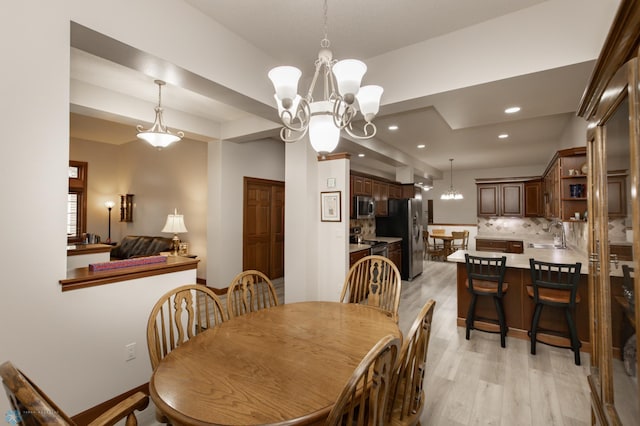 1365 Highpointe Dr N, Fargo, ND 58102 - dining area with a chandelier, light wood finished floors, and recessed lighting