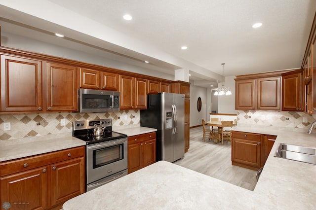 1365 Highpointe Dr N, Fargo, ND 58102 - kitchen with appliances with stainless steel finishes, light countertops, recessed lighting, and backsplash
