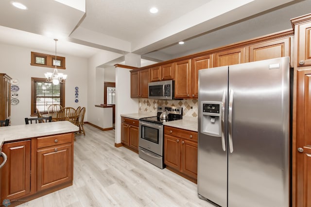 1365 Highpointe Dr N, Fargo, ND 58102 - kitchen featuring appliances with stainless steel finishes, brown cabinets, backsplash, light countertops, and recessed lighting