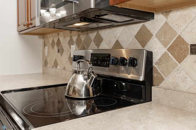 1365 Highpointe Dr N, Fargo, ND 58102 - kitchen view of electric stove, backsplash, light countertops, and range hood