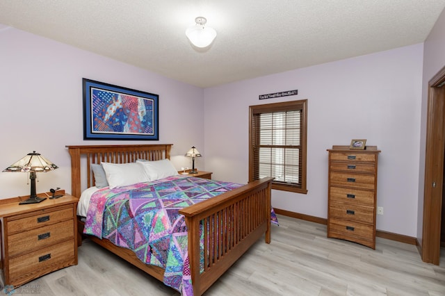 1365 Highpointe Dr N, Fargo, ND 58102 - bedroom with light wood-type flooring and a textured ceiling