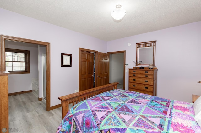 1365 Highpointe Dr N, Fargo, ND 58102 - bedroom featuring light wood finished floors and a textured ceiling