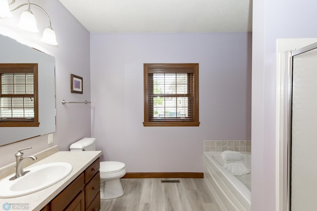 1365 Highpointe Dr N, Fargo, ND 58102 - bathroom featuring vanity, a garden tub, wood finished floors, and a shower with shower door
