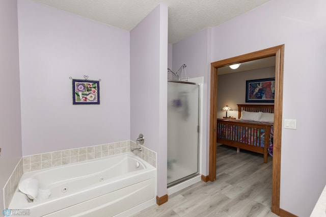 1365 Highpointe Dr N, Fargo, ND 58102 - bathroom with a stall shower, a tub with jets, and wood finished floors