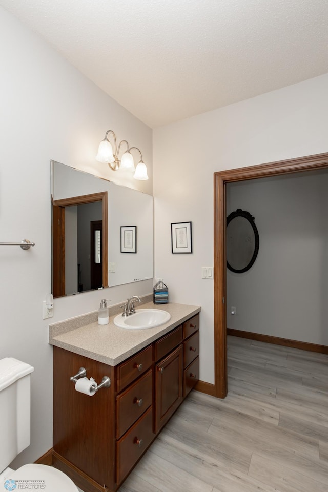 1365 Highpointe Dr N, Fargo, ND 58102 - half bath featuring vanity and wood finished floors