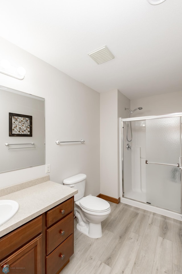 1365 Highpointe Dr N, Fargo, ND 58102 - bathroom with vanity, wood finished floors, and a shower stall