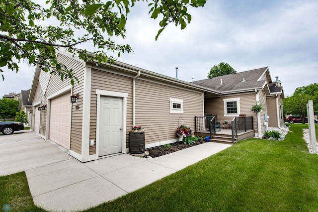 1365 Highpointe Dr N, Fargo, ND 58102 - rear view of property featuring a deck, driveway, a lawn, and an attached garage