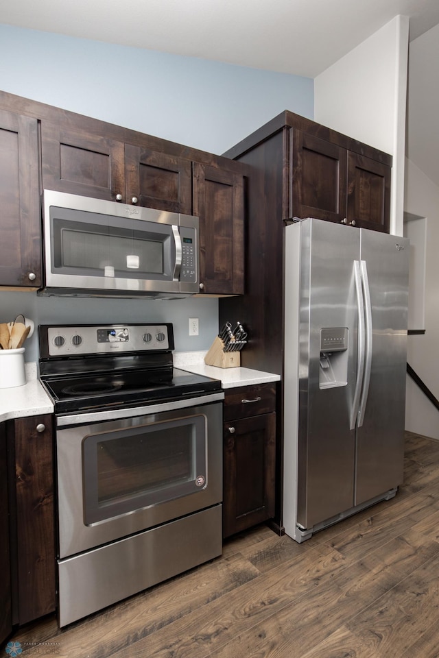 6675 57th Ave S, Fargo, ND 58104 - kitchen featuring stainless steel appliances, dark brown cabinets, dark wood-style floors, and light countertops