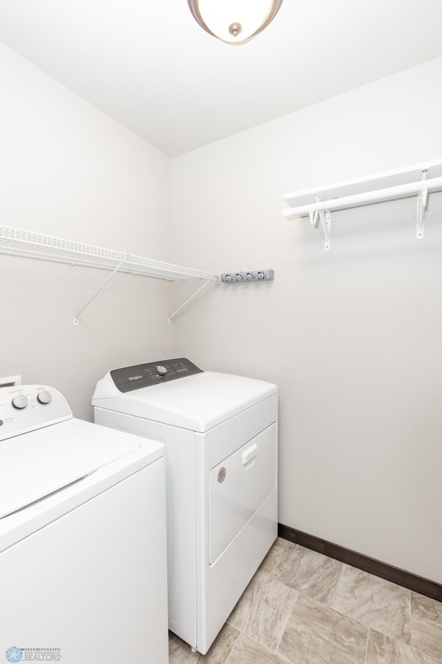 6675 57th Ave S, Fargo, ND 58104 - laundry room with washing machine and clothes dryer and baseboards
