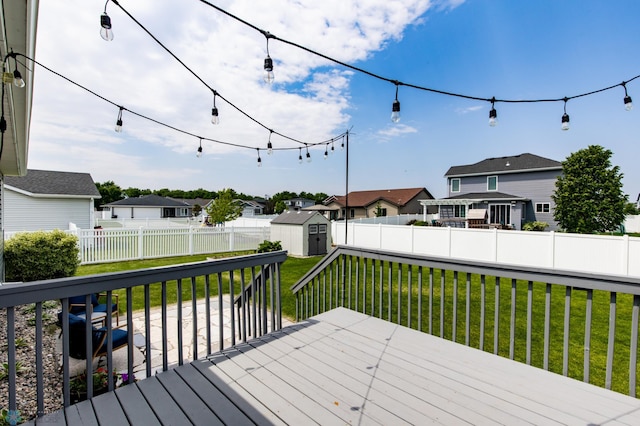 6675 57th Ave S, Fargo, ND 58104 - wooden terrace featuring a storage shed, a residential view, and a fenced backyard