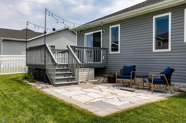 6675 57th Ave S, Fargo, ND 58104 - back of property featuring a wooden deck, a patio area, and roof with shingles