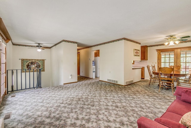 10275 Park Cir, Pine City, MN 55063 - carpeted living room featuring ceiling fan, crown molding, and baseboards